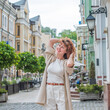 © T.Den_Team - Smiling Redhead Woman in City. Candid Moments. Lady  in her late 30s or early 40s, smiling sincerely in an urban setting