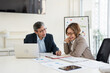 © Fahng - People, clipboard , tablet laptop and paperwork in office for planning, problem solving or budget meeting. Teamwork looking in paper for opinion, review feedback brainstorming productivity at paper