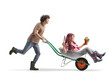 © Ljupco Smokovski - Young man running and pushing a woman seated in a wheelbarrow