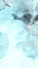 Aufkleber - Super slow motion of rotating ice cubes in water. Filmed on high speed cinema camera, 1000 fps. Underwater composition. Vertical aspect ratio.