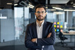 © Liubomir - Portrait of serious confident businessman at workplace inside office. Man with crossed arms looking at camera, financier investor in business suit.