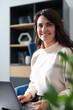© Andrii Zastrozhnov - Caucasian female adult smiling while using laptop in office setting