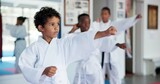 Exercise, karate and sports with kids in dojo for combat, fighting or self defense training. Fitness, learning or growth with group of boy children in class for martial arts lesson or practice