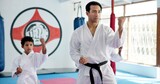 Sensei, lesson and man with kids in karate class, self defense training or martial arts with youth for combat education. Taekwondo, fight and male instructor with student children coaching in dojo