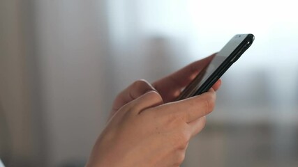 Aufkleber - Woman Using Smartphone to Browse Social Media and Communicate in a Cozy Indoor Setting During the Afternoon