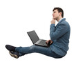 © 1STunningART - Thinking positive, young businessman sitting down on floor using laptop on his knees, dreaming with hand under chin. Imagining holiday, Network travel concept
