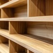 © AndiMagfira - Empty light wood shelving unit detail