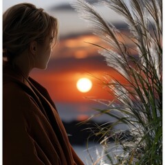 Poster - A woman is standing in front of a plant with a sunset in the background