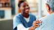 © peopleimages.com - Senior woman, nurse and hand on shoulder for support, healthcare and medical wellness in home. Retirement, patient and comfort with caregiver in living room for help, kindness and empathy with trust