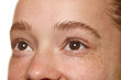 © master1305 - Side close-up a young woman eyes and eyebrow, showcasing natural skin with freckles isolated over white background. Concept of natural beauty, skin care, cosmetology and organic cosmetics