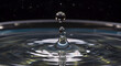 © RIKO - Captivating Water Drop Moment Suspended In Time With Ripple Formation