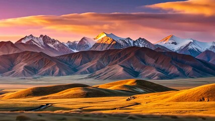 Poster - Golden hour illuminates majestic snow-capped peaks and rolling hills in a breathtaking landscape.