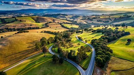 Poster - Serene Country Road Winding Through Lush Green Hills and Valleys at Sunset