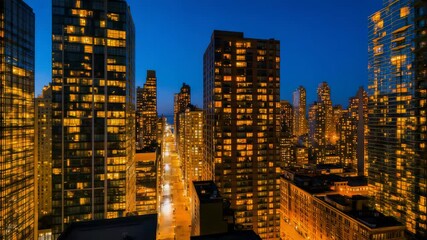 Aufkleber - Warm lights illuminating the numerous apartments and offices of the impressive skyscrapers of new york city at twilight, creating a breathtaking urban nightscape