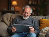 Senior Man Video Calling Family on Tablet – Elderly Technology Use at Home