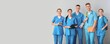 © Pixel-Shot - Group of medical students on grey background with space for text