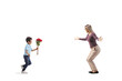 © Ljupco Smokovski - Full length profile shot of a boy with flowers running towards a woman