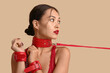 © Pixel-Shot - Sexy young woman in red handcuffs and collar on color background. Erotic concept