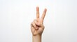 © Fan_ - Hand Showing Peace Sign on White Background for Victory or Success