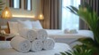 © harjiyo - Rolled white towels neatly stacked on a hotel bed
