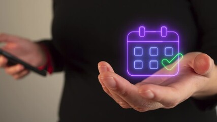 Poster - Woman's hand holding a virtual neon icon of a calendar with a check mark
