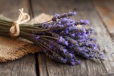 A close-up of a bunch of lavender on a weathered wooden surface.