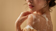© Iryna - A young woman in shower with a foam on the shoulder
