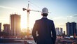 © 문용 최 - An urban industrial site where a high-rise building is being constructed with a crane moving on the background of a man in a suit