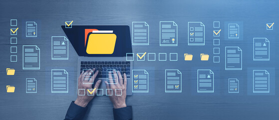 Poster - Hands typing on laptop with digital document icons and folders on blue surface background.