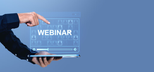 Poster - Webinar concept with hand pointing to digital screen above tablet on blue background.