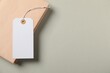 © New Africa - Blank tag with string and book on grey background, top view. Space for text