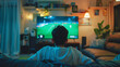 © Taiwo - Teen watching tv in a dark Livingroom, campo de fútbol. Big entertainment sport person, fan sitting back view watching television screen  streaming. Tv back engagement  gaming room