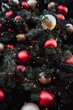 © Александра Ходорковс - Festive christmas tree with red and gold ornaments and twinkling lights