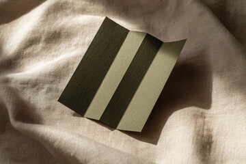 Poster - Striped textured paper mockup on beige fabric background, showcasing elegant minimalism and free space for text or branding