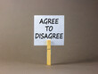 © Dzmitry - Agree to disagree symbol. Concept words Agree to disagree on beautiful white paper on wooden clothespin. Beautiful grey background. Business and agree to disagree concept. Copy space.