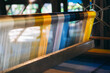 © NewSaetiew - Silk thread from weaving machine traditional craft, a vibrant tapestry of color.