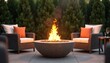 © miss irine - Bright fire pit on patio setting. Comfortable chairs and side table with glass of wine. Evening outdoor gathering, relaxation at home. Warm ambiance, cozy, relaxing, entertaining.