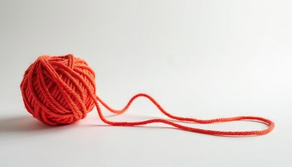 Poster - Close-up photo ball of orange yarn on white. Ball of yarn with long tail. Thread textile fiber wool cotton handmade. Knit, crochet, craft hobby. Arts crafts design.