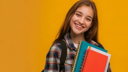 Poster - A smiling young woman with books and a backpack against a solid backdrop. She appears to be a student, possibly heading to or from class. This could represent education or youthful enthusiasm.