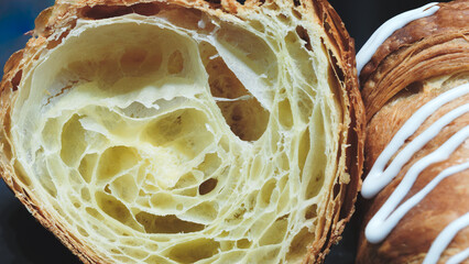 Poster - A pastry with a hole in it and a white icing on top. The pastry is open to show the inside
