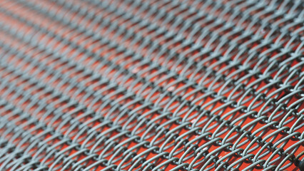 Poster - A close up of a silver chain with red background.  chain is made of metal and is very thin