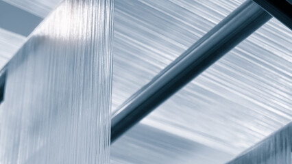 Aufkleber - synthetic textile thread,  thread at industrial weaving manufacturing machine,  textile fabric production industrial concept background