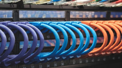 Poster - multi-colored fiber optic wires inserted into electronic switching unit, industrial internet communication concept background