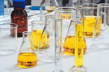 Poster - Glass vials with urine samples on laboratory table in medical analytical laboratory in hospital. pharmaceutical chemistry concept background