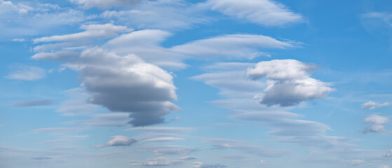 Aufkleber - heaven sky is blue with a few clouds scattered throughout. The clouds are white and fluffy, giving the sky a peaceful and serene.
