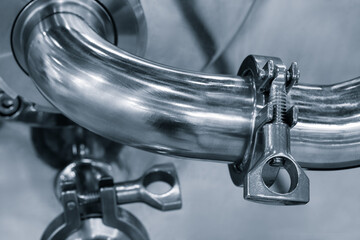 Poster - A silver pipe with a nut on it. The nut is tightened and the pipe is bent. Concept of strength and stability.