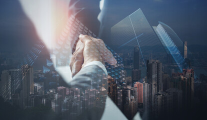 Business, finance and investment background. Business handshake, businessman shaking hand double exposure with office buildings and smart city, successful deal of global business