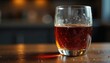 © Sourithideth - Close-up of a half-empty glass of dark liquid, condensation visible on the surface , strong, half-full, dark