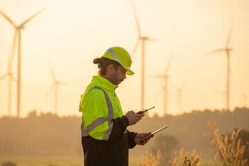 Aufkleber - Engineer man working with tablet at windmill farm Generating electricity clean energy. Wind turbine farm generator by alternative green energy.