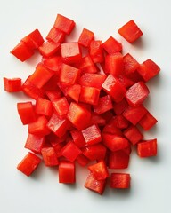 Poster - Overhead studio shot of diced red bell pepper on white surface for food preparation and cooking concepts